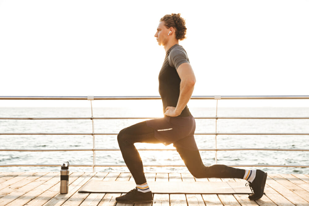 Man doing Lunges on Beach